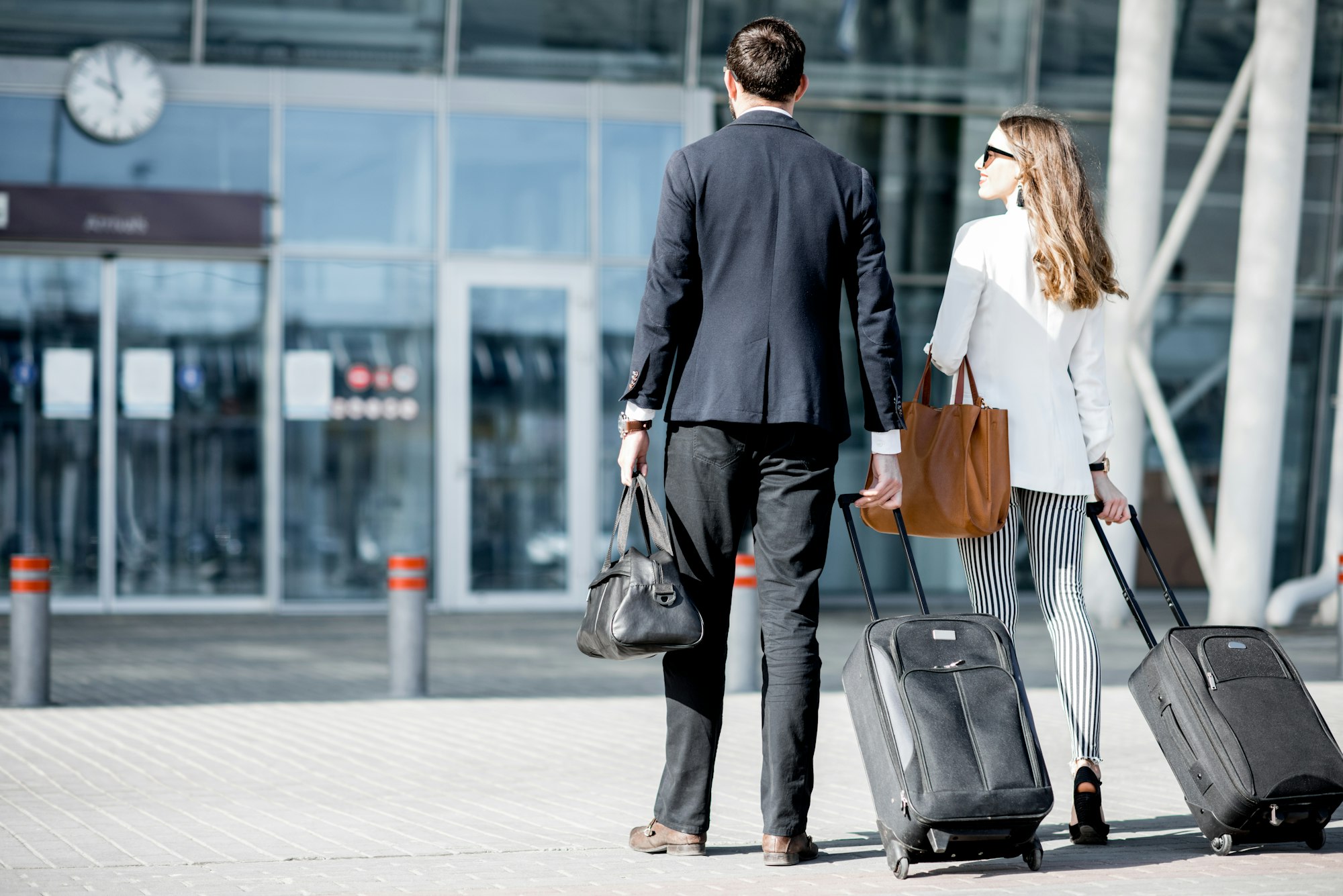 Business couple walking to the airport